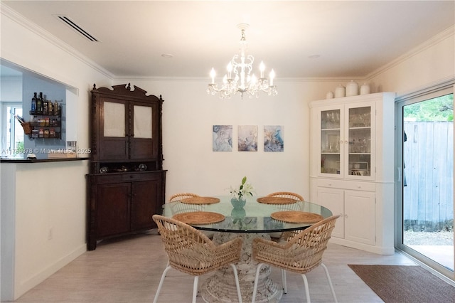 dining area with a notable chandelier, visible vents, ornamental molding, light wood-type flooring, and baseboards