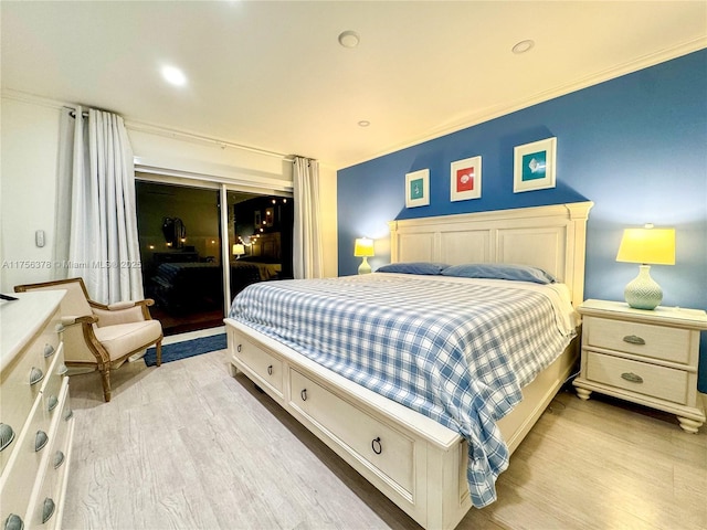 bedroom with light wood-style floors and ornamental molding