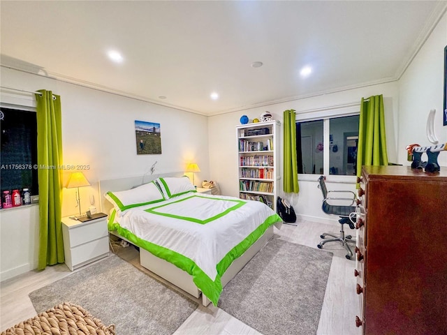 bedroom with ornamental molding, recessed lighting, wood finished floors, and baseboards