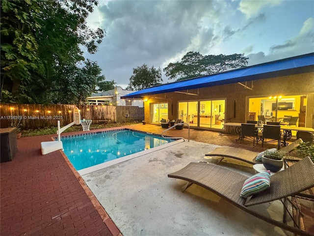 view of swimming pool with a patio area, fence, and a fenced in pool