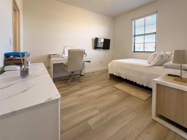 686 NE 191st Ter, Miami, FL 33179 - bedroom featuring light wood finished floors, a desk, and baseboards