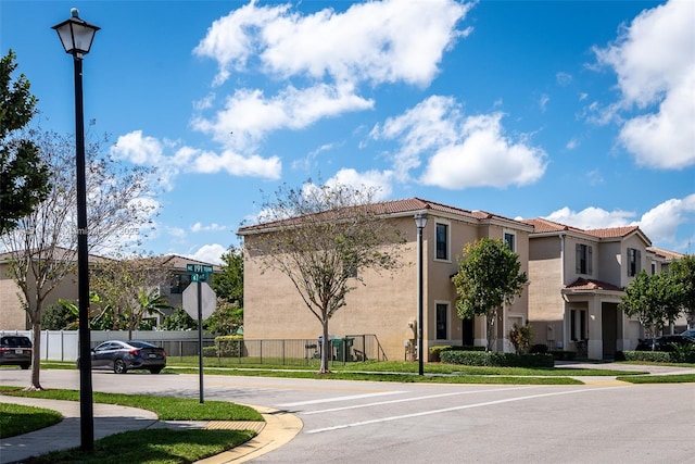 686 NE 191st Ter, Miami, FL 33179 - view of property featuring fence, uncovered parking, and a residential view