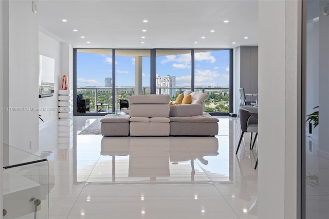 living room featuring a view of city, recessed lighting, and floor to ceiling windows