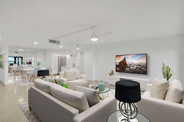 living room with light tile patterned floors, visible vents, a ceiling fan, and recessed lighting