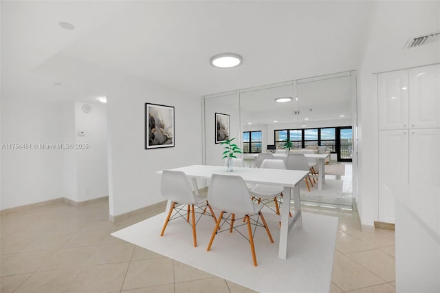 dining room with baseboards, visible vents, and light tile patterned flooring