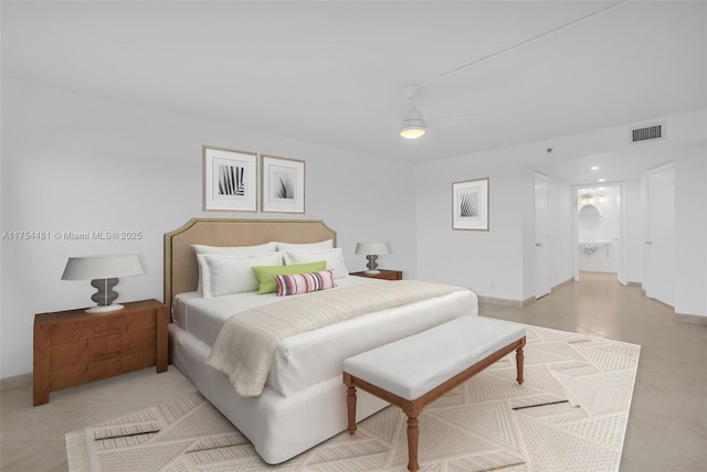 bedroom featuring ensuite bath, visible vents, and a ceiling fan