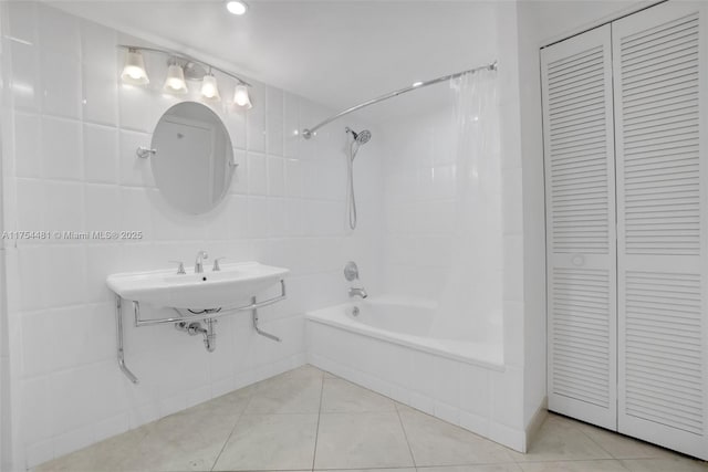 bathroom with shower / bathtub combination with curtain, a closet, tile walls, and tile patterned floors