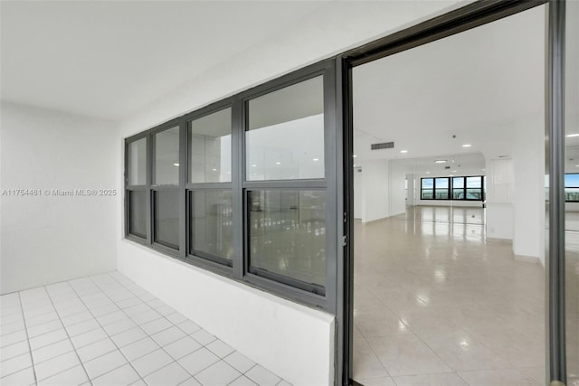 interior space with light tile patterned flooring and visible vents