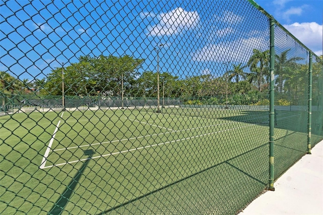 view of sport court featuring fence