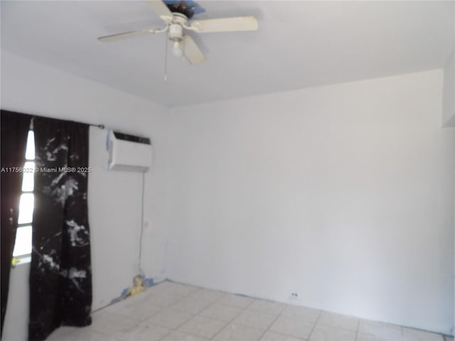 spare room featuring ceiling fan and a wall mounted air conditioner