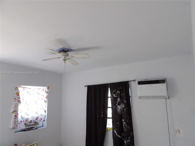 interior space featuring ceiling fan and a wall mounted AC