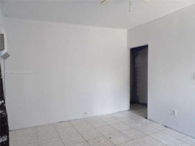 spare room with light tile patterned flooring and a ceiling fan