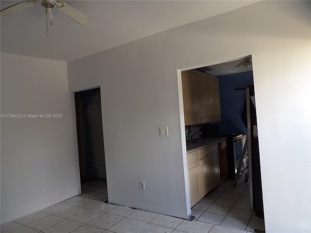 kitchen with light tile patterned flooring, a sink, and a ceiling fan