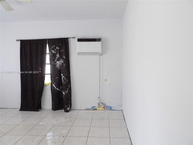 tiled empty room with a ceiling fan and a wall mounted AC