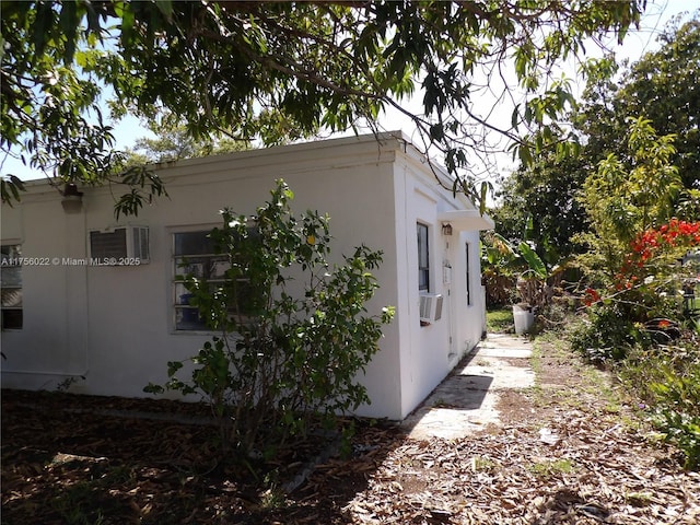 view of side of home with stucco siding