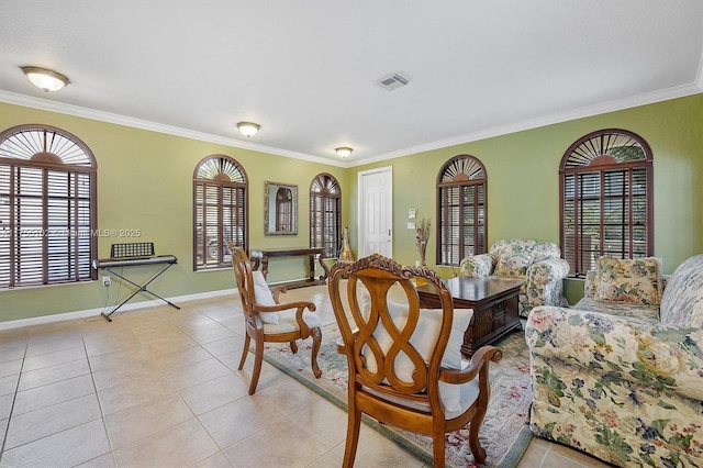 dining space featuring light tile patterned floors, visible vents, a wealth of natural light, and ornamental molding