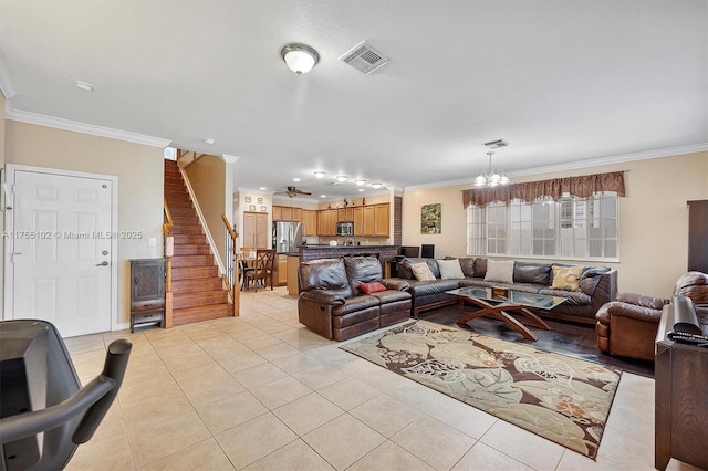 living area with stairs, visible vents, crown molding, and light tile patterned floors