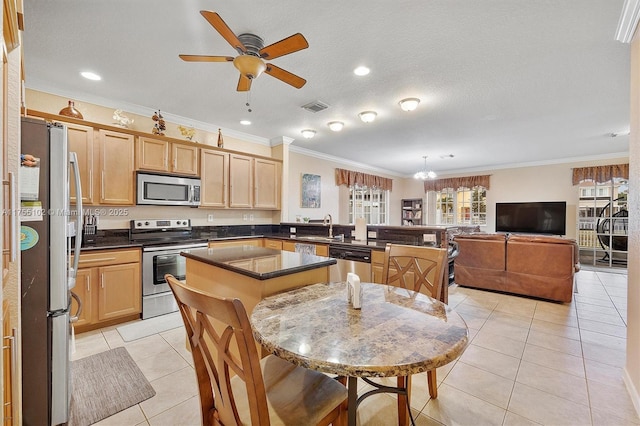 kitchen with visible vents, dark countertops, appliances with stainless steel finishes, light brown cabinets, and light tile patterned flooring