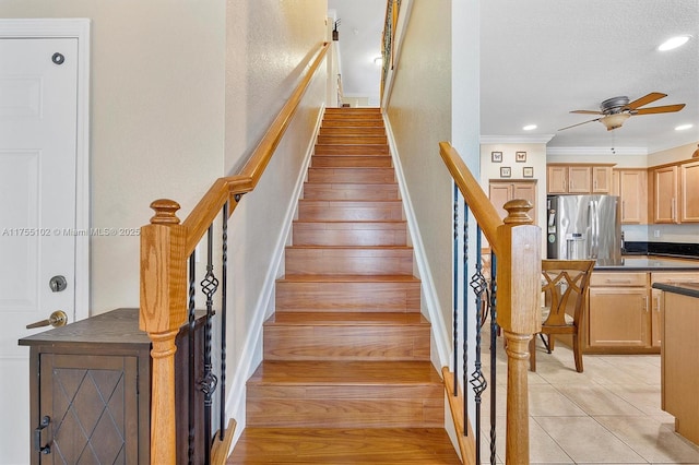 staircase featuring ceiling fan, crown molding, tile patterned flooring, and recessed lighting