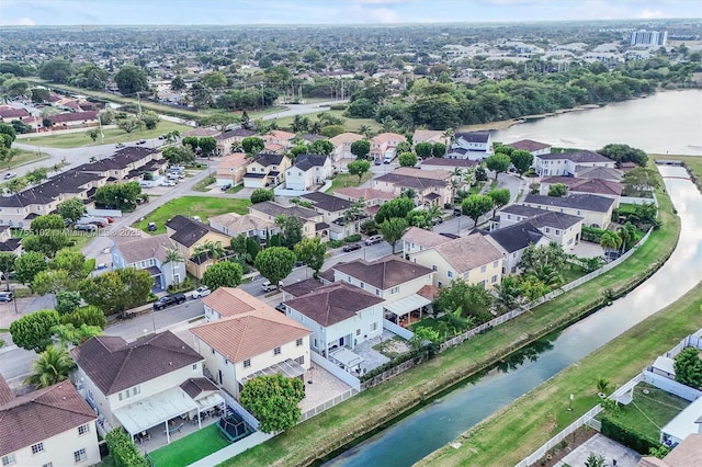 drone / aerial view with a water view and a residential view