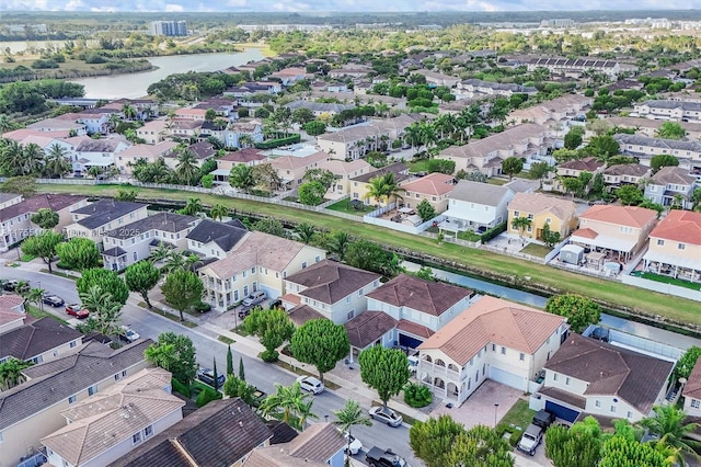 birds eye view of property featuring a water view and a residential view