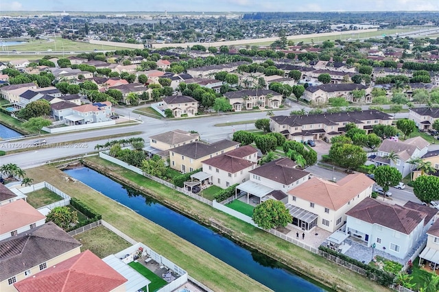 drone / aerial view featuring a residential view and a water view