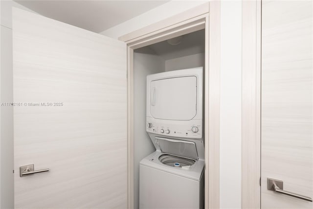 laundry area with stacked washer and clothes dryer and laundry area