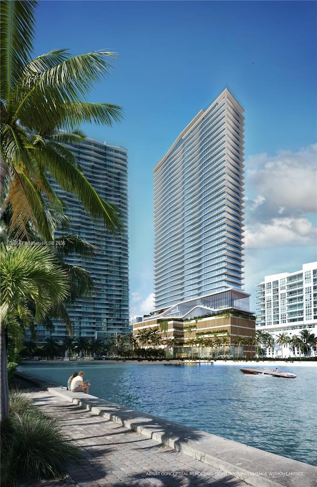 workout area featuring a water view and expansive windows