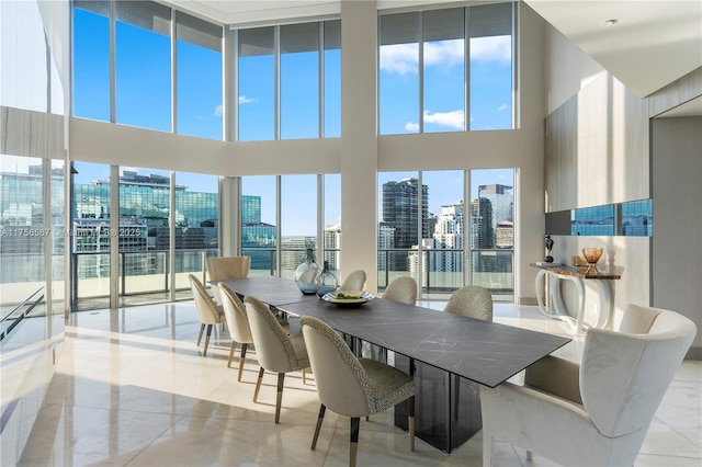 dining area with a towering ceiling and a view of city