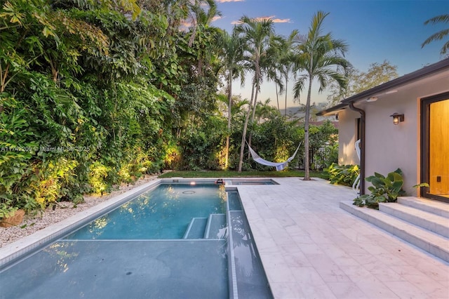 pool featuring a patio area