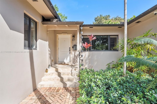 property entrance with stucco siding