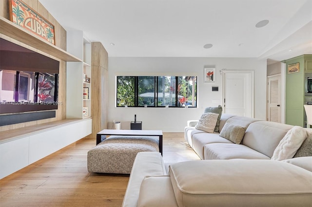 living room featuring lofted ceiling and hardwood / wood-style flooring