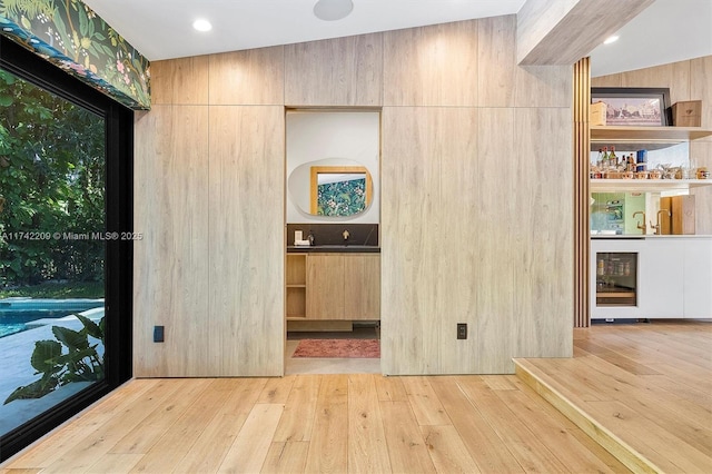 interior space featuring a dry bar and hardwood / wood-style floors