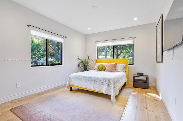 bedroom with recessed lighting, baseboards, and light wood finished floors