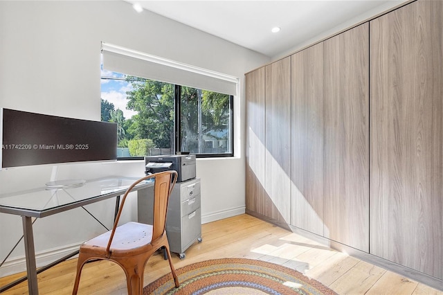 home office featuring light wood finished floors, baseboards, and recessed lighting