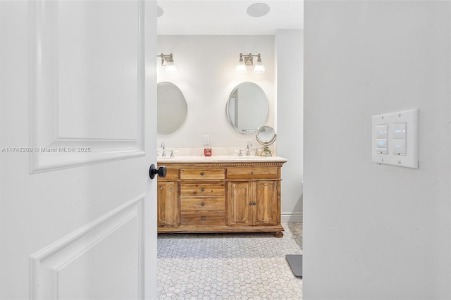 bathroom with tile patterned flooring, a sink, and double vanity