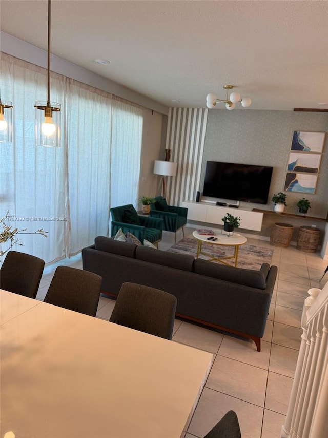 living room featuring light tile patterned floors and wallpapered walls