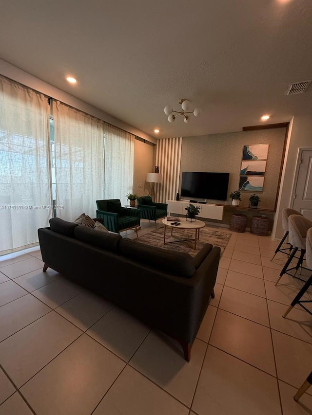 living area featuring recessed lighting, visible vents, a textured ceiling, and light tile patterned floors