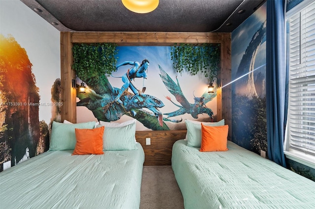 bedroom featuring carpet floors and a textured ceiling
