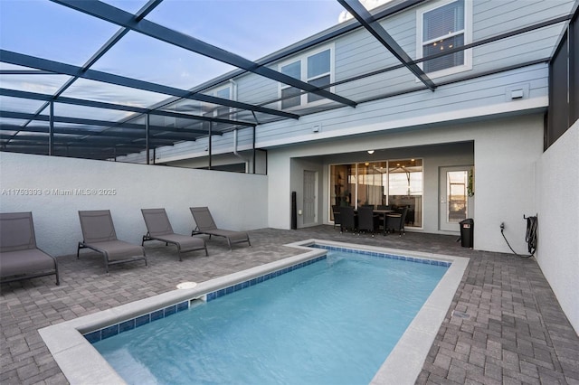 outdoor pool featuring a lanai and a patio area
