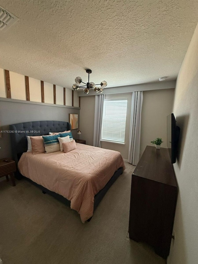 bedroom with carpet, visible vents, a notable chandelier, and a textured ceiling