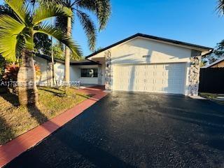 view of front of property with driveway and an attached garage