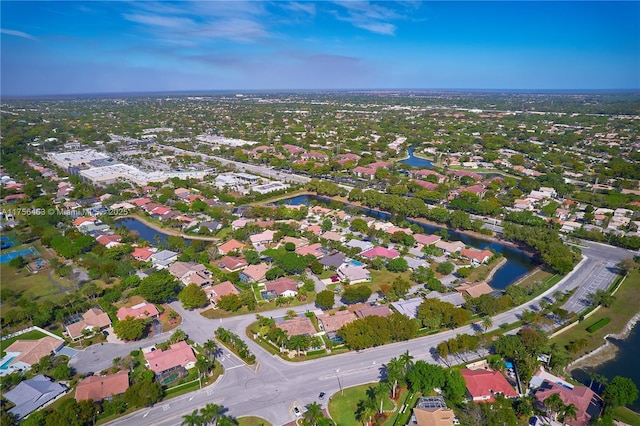 drone / aerial view with a water view and a residential view