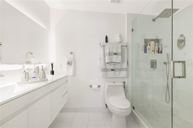 bathroom with vanity, tile patterned flooring, a shower stall, and toilet