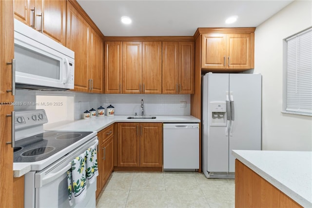 300 Berkley Rd Unit 107, Hollywood, FL 33024 - kitchen with white appliances, brown cabinetry, light countertops, and recessed lighting