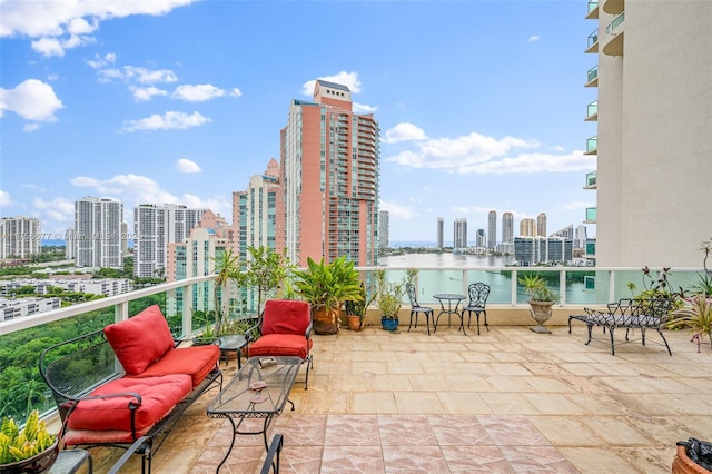 balcony with a view of city and a water view