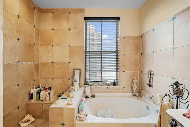 bathroom with a garden tub and tile walls