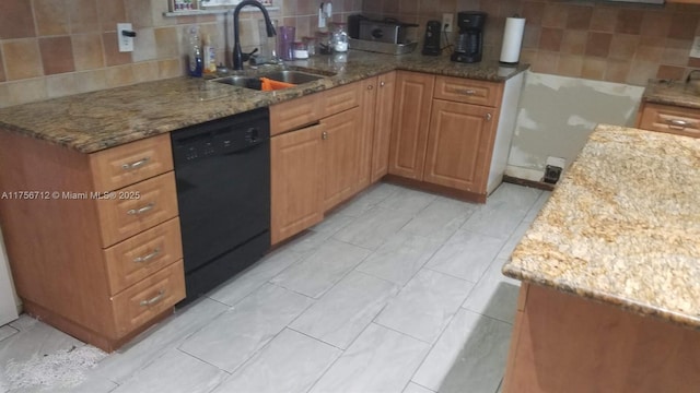 kitchen featuring dishwasher, decorative backsplash, a sink, and light stone countertops