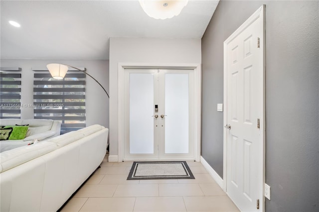 foyer with light tile patterned floors and baseboards