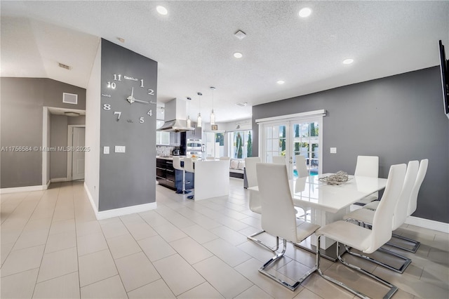 dining room featuring visible vents, french doors, baseboards, and vaulted ceiling